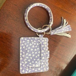 Wristlet that holds space to put your credit cards, license,and money.